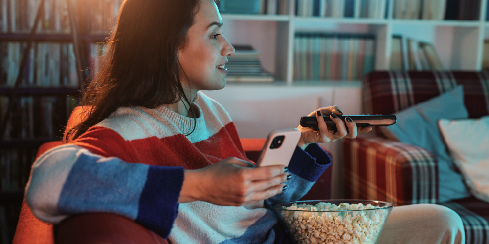 Woman on a diet eating popcorn while watching a movie